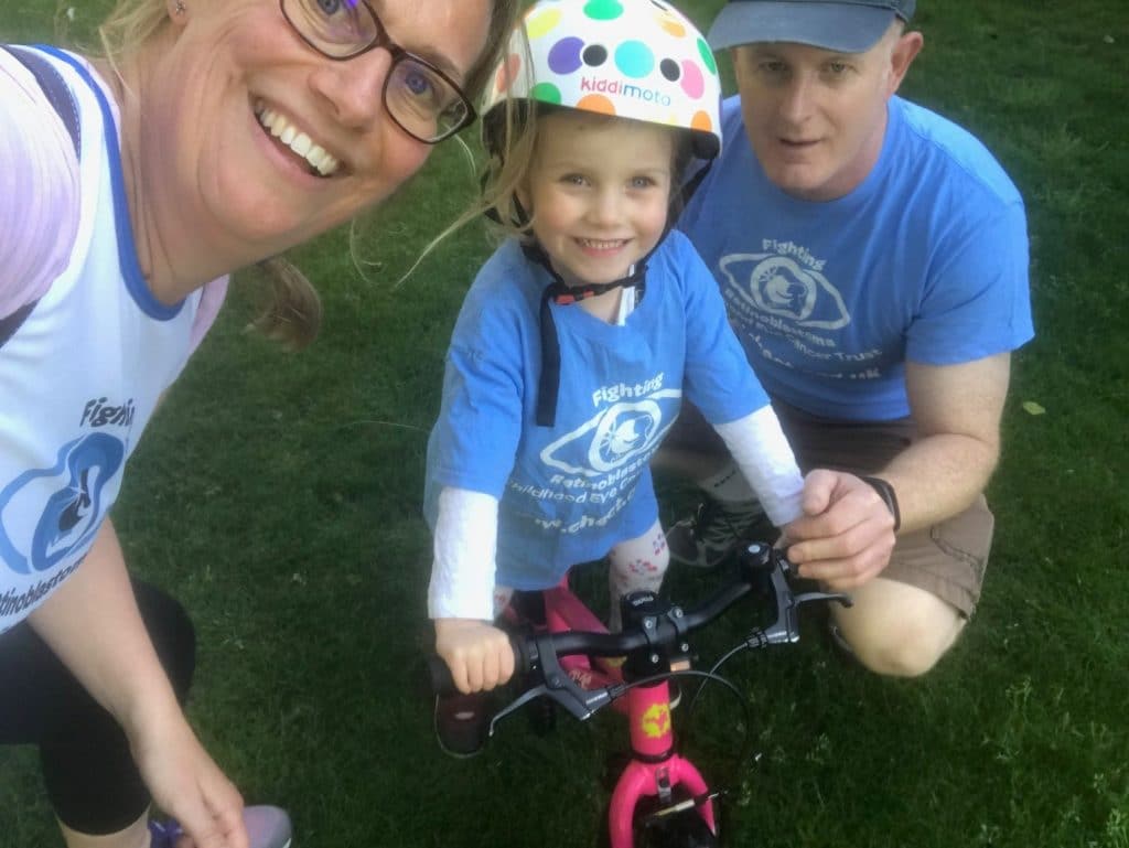Amber, mum Pippa and Dad Glenn all wearing CHECT Tshirts. Pippa is riding her bike.