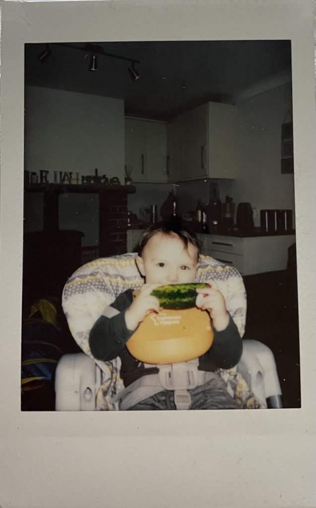 A polaroid photo of Elijah with a white glow