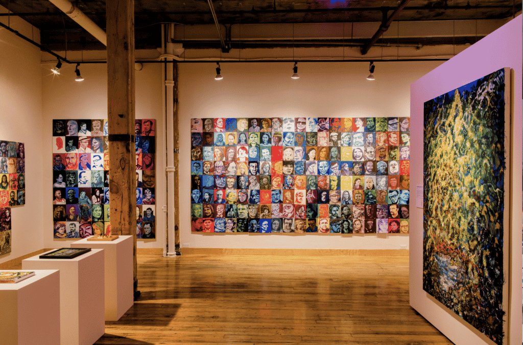 Portraits by Bruce Horak in a gallery. Tangled Gallery Installation, Toronto. Michelle Peek Photography courtesy of Bodies in Translation/ Activist Art, Technology & Access to Life, Re•Vision/ The Centre for Art & Social Justice at the University of Guelph. 