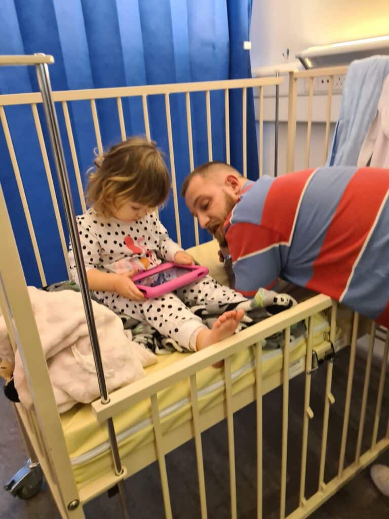 Darecy-Rose playing on an iPad in a hospital