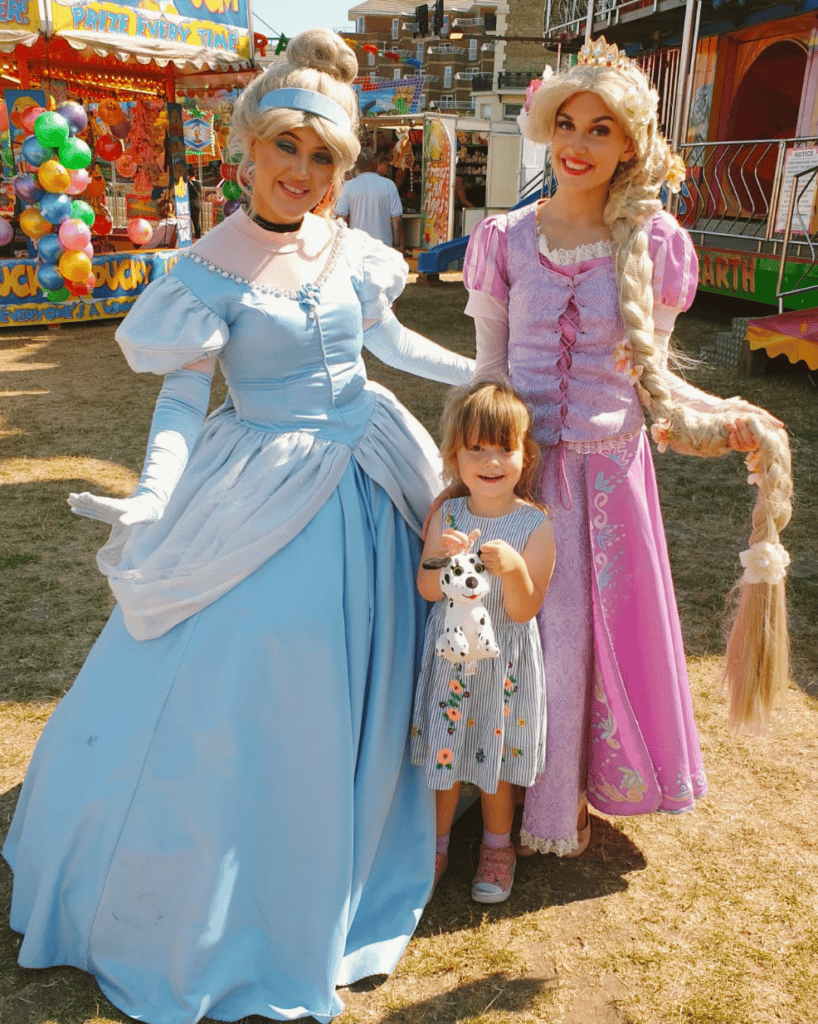 Darcey smiling with two princesses