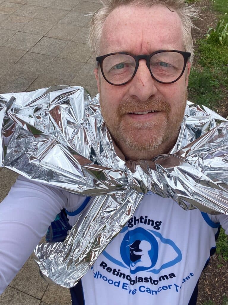 Arran smiling with a CHECT vest on