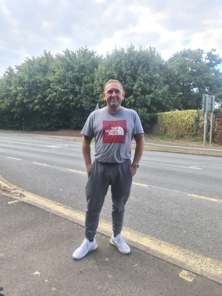 Chris stood outside smiling