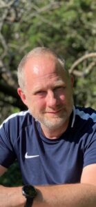 Mark smiling outside