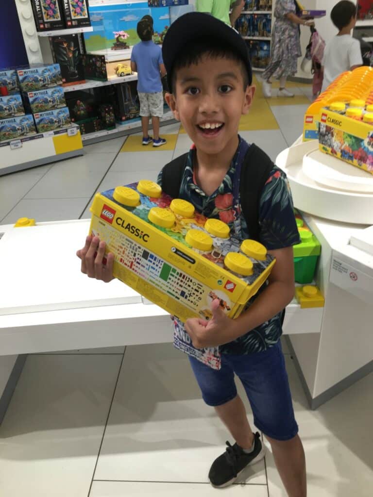 William smiling holding lego blocks