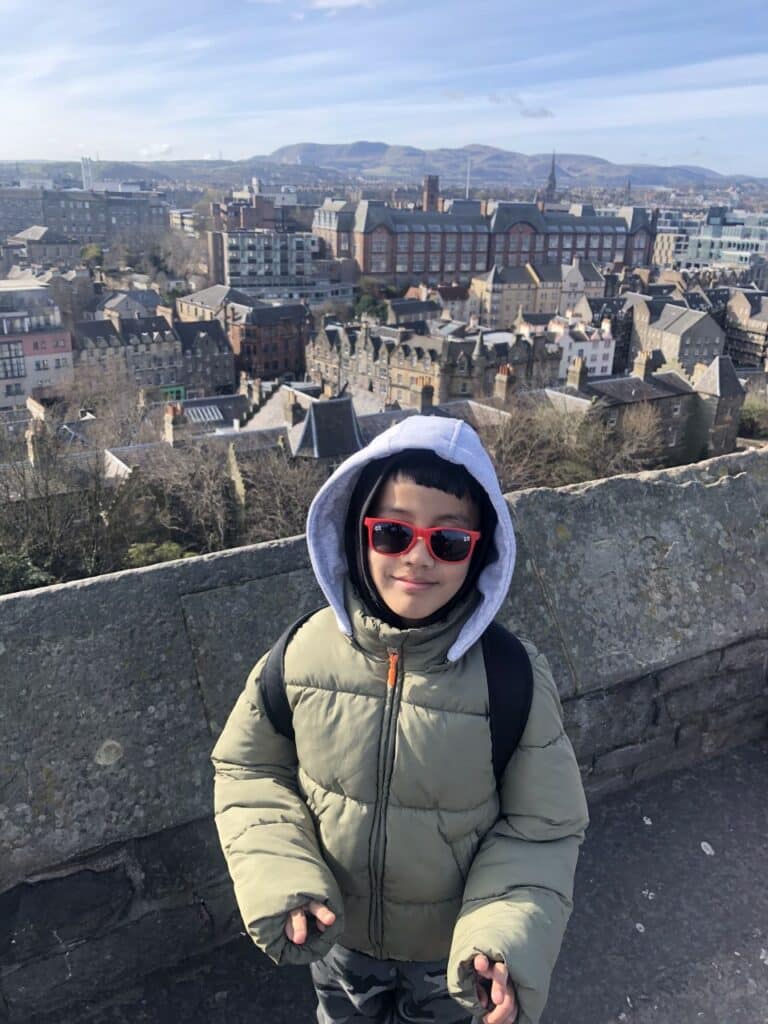 William stood outside with a nice view behind him, smiling