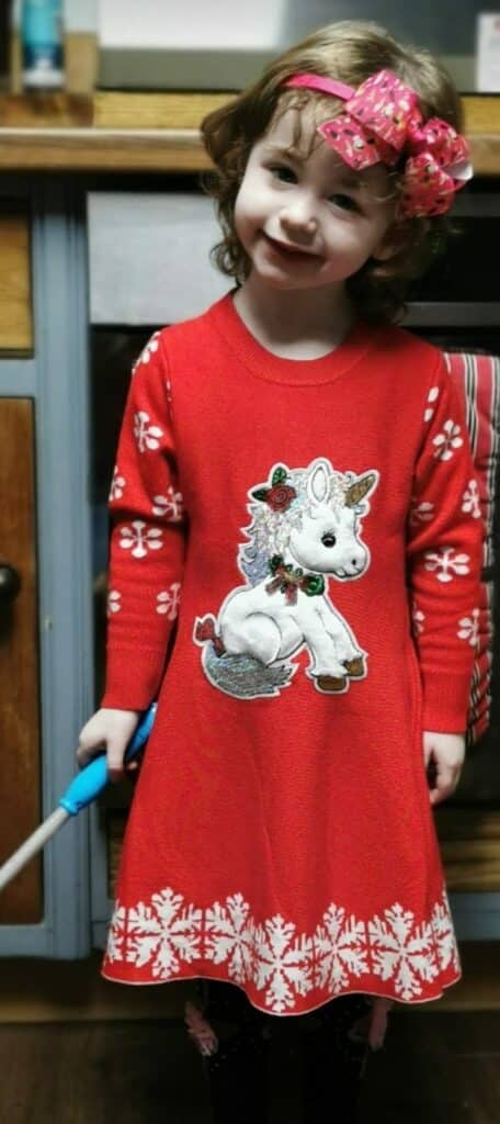 Bonnie in her Christmas dress smiling at the camera