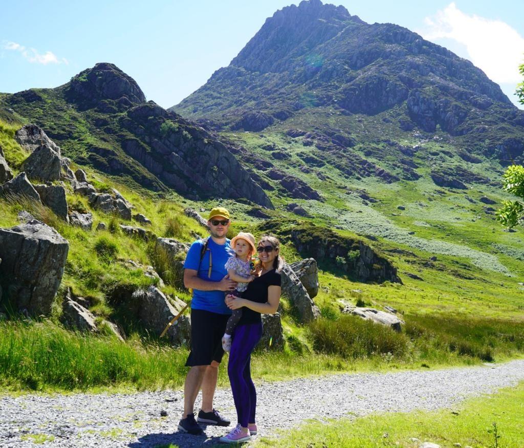 Olivia and her parents with mountains in the background after being diagnosed with retinoblastoma