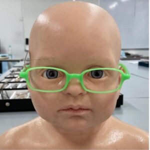 A dolls head with specs on