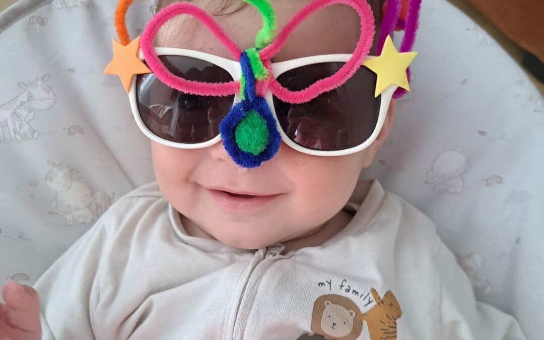 A baby wearing crazy glasses
