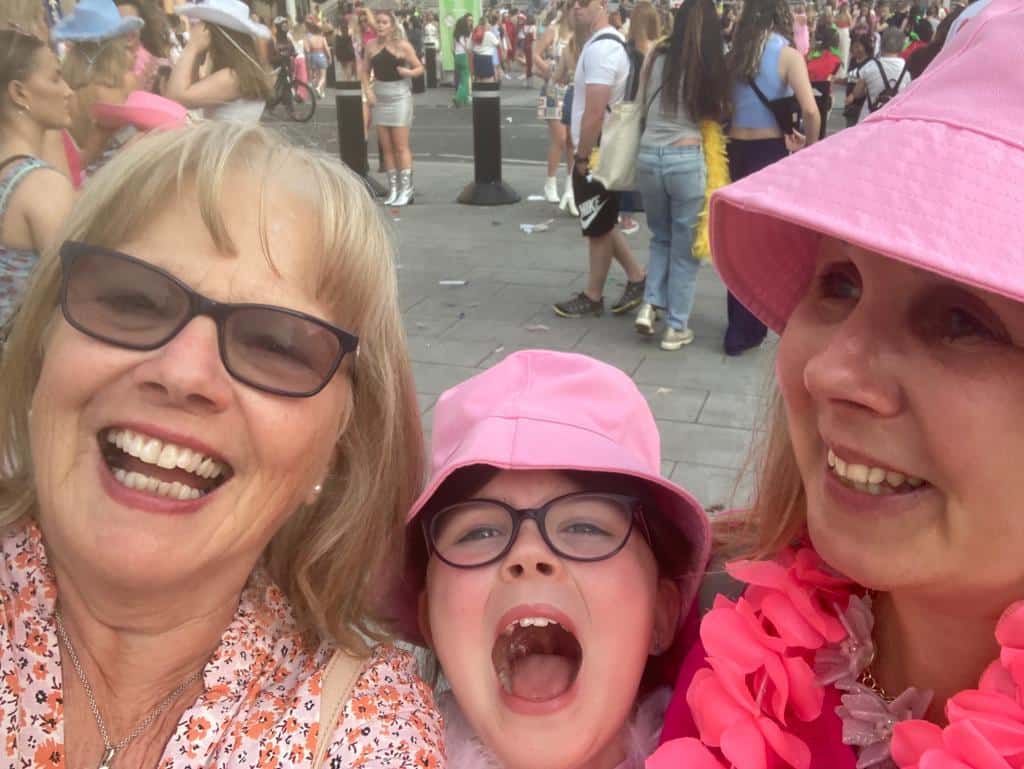 A happy photo of the three guests smiling outside the venue