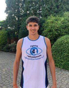 Oliver is stood outside in a CHECT vest