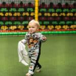 A toddler walking in a costume