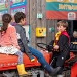 Three children sat on a tractor