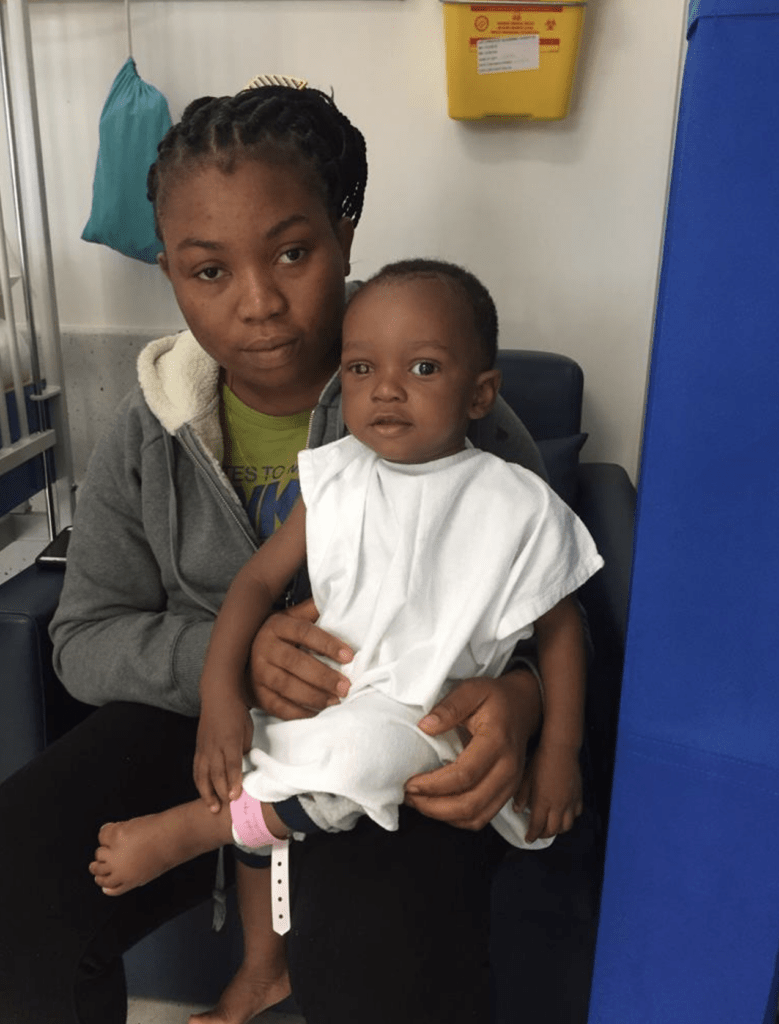 Joseph is sat on his mum's lap 