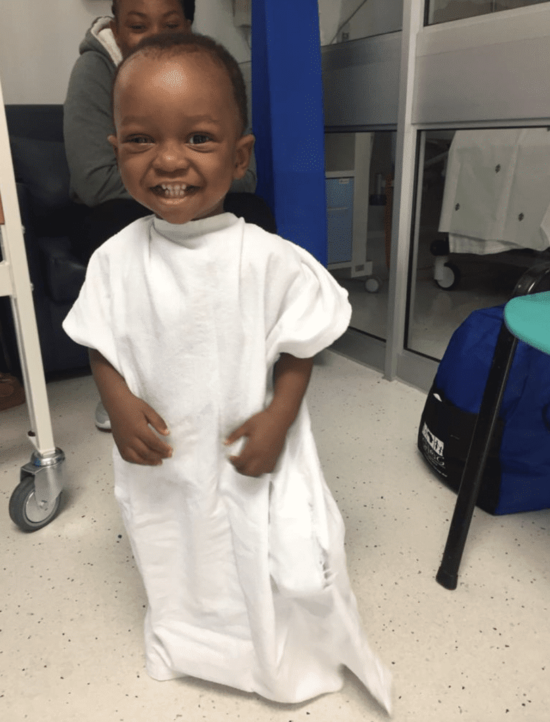 Joseph is smiling in a white hospital gown