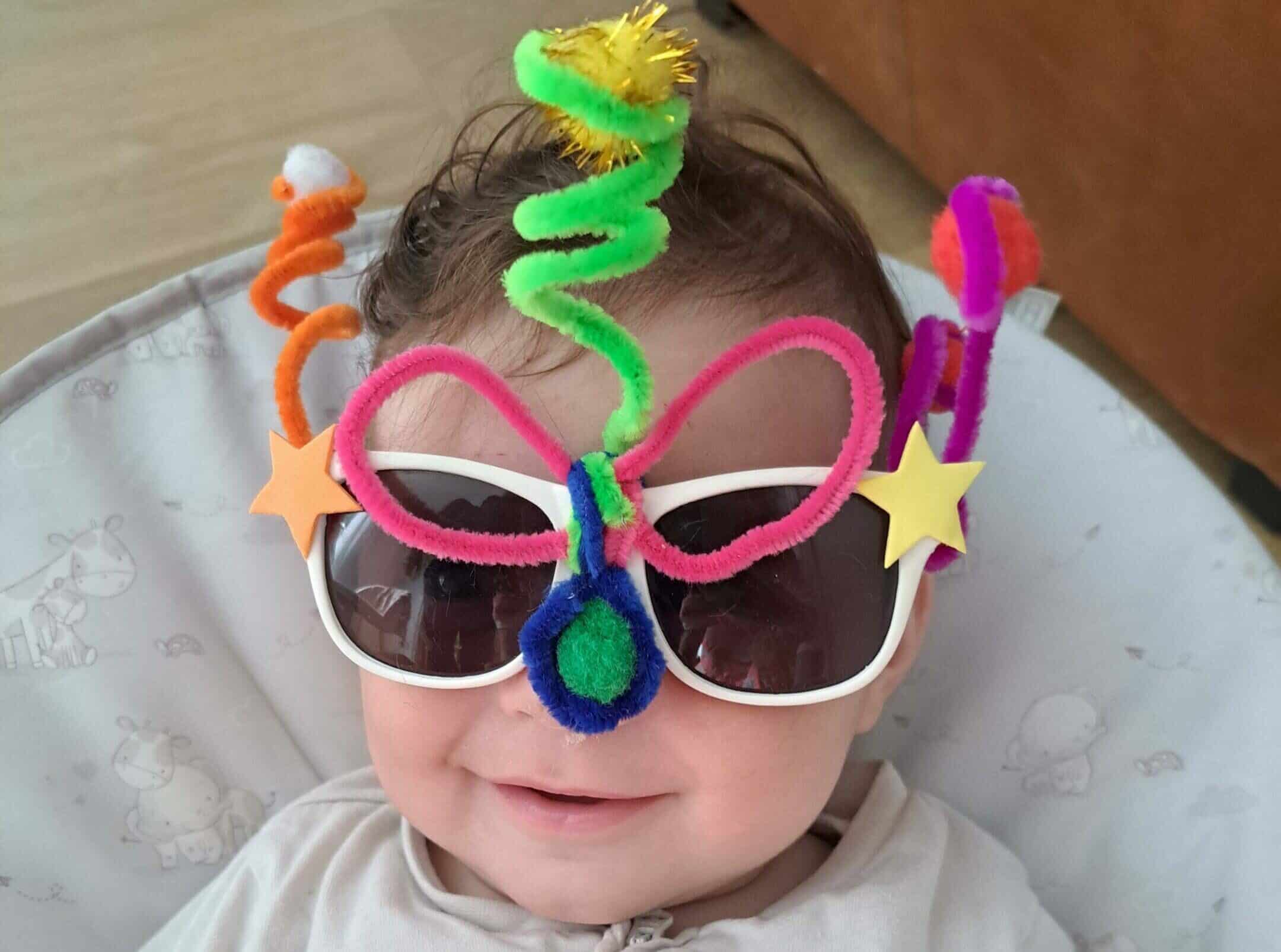 RS7272_20230519_082615 (1) a baby wearing crazy glasses made out of pipe cleaner to fundraise for CHECT