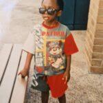 Michael is a boy, stood with sunglasses on