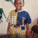 Michael as a boy smiling at the camera