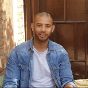 Tom sat inside smiling