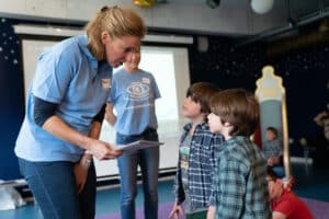 Petra is handing a boy a certificate