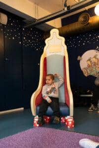 A boy is sat on a chair