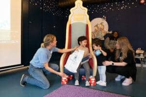 Lena is handing a boy a bag of goodies