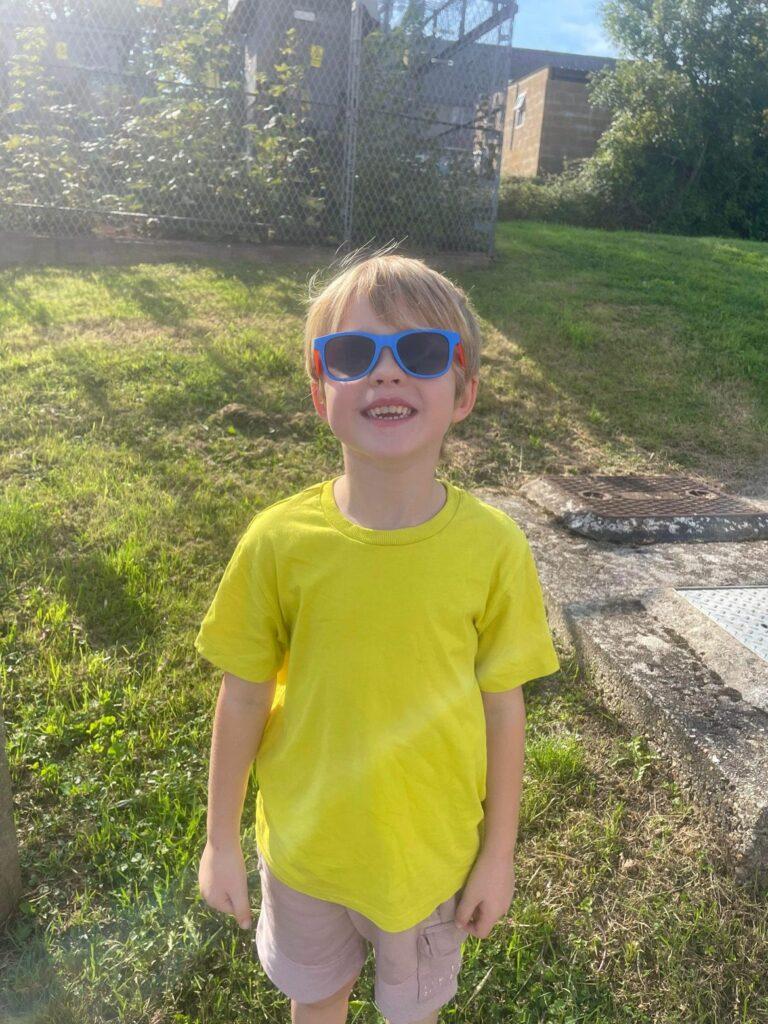 Arlo stood outside wearing sunglasses
