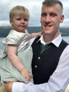 Thomas his holding his daughter