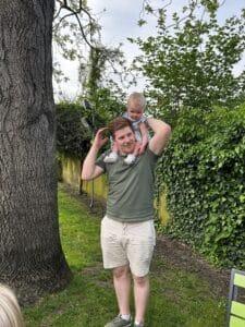 Robbie has his child on his shoulders