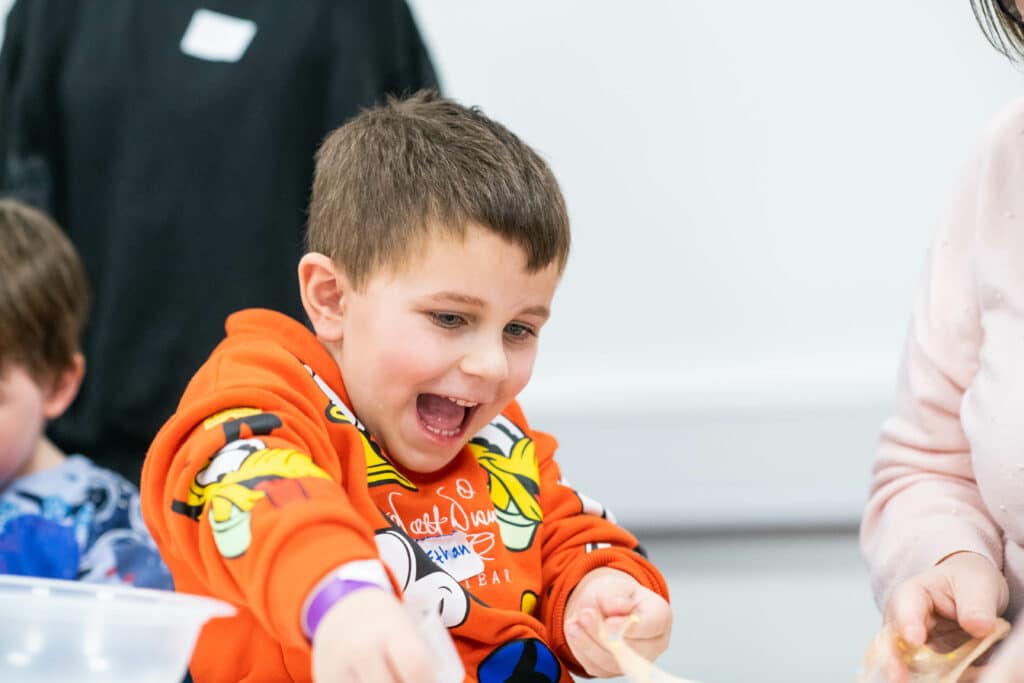 Ethan smiling at a CHECT event