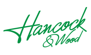 Green cursive writing of spelling out Hancock & Wood - the name of a company that supports Childhood Eye Cancer Trust