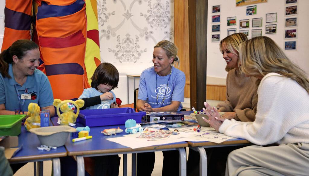 Lena, Nadine and Kimberley are doing lego with one of the children