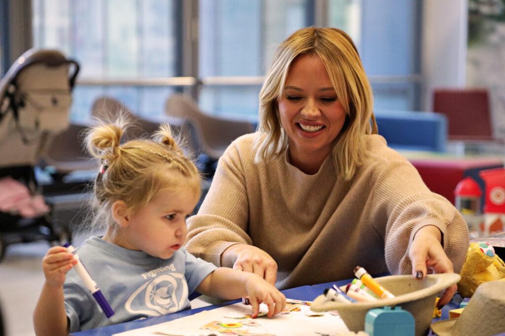 Kimberley is doing arts and crafts with Robyn