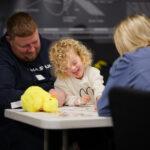 A girl is smiling with her dad