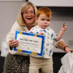 A toddler receives his certificate