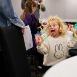 A girl wearing a bunny top has a huge smile