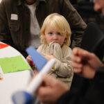 A child is holding a blanket
