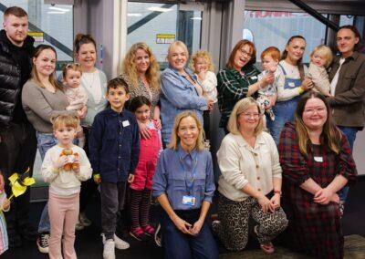 A group of families and CHECT staff posing together at the National Space Centre in Leicester after a family event