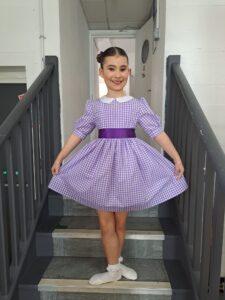 Martha is posing in a beautiful purple dress