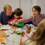 Children and an adult doing crafys