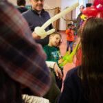 Children and adults with balloon animals