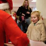 A child is smiling at a support team member