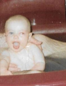 Adam as a baby with a white glow in one eye