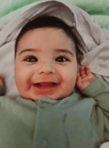 Shuhd as a baby with a white glow in her eye