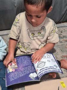 Junior is sat reading the book