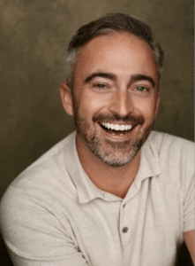 Gavin has a headshot of him smiling widely